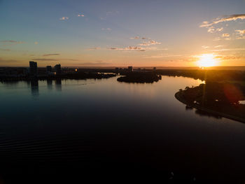 Scenic view of river against sky during sunset