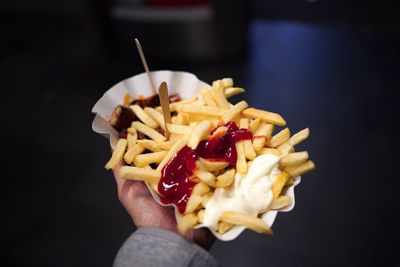 Close-up of hand holding hot dog