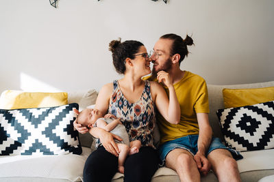 Young couple sitting on sofa at home