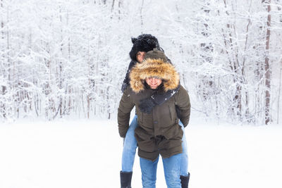 Woman standing on snow covered land