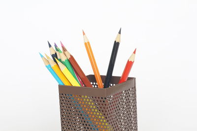 Close-up of multi colored pencils against white background