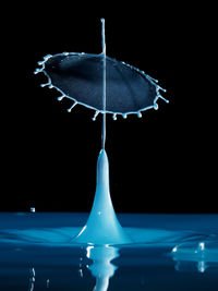 Close-up of water splashing over black background