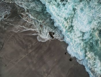 High angle view of waves rushing towards shore