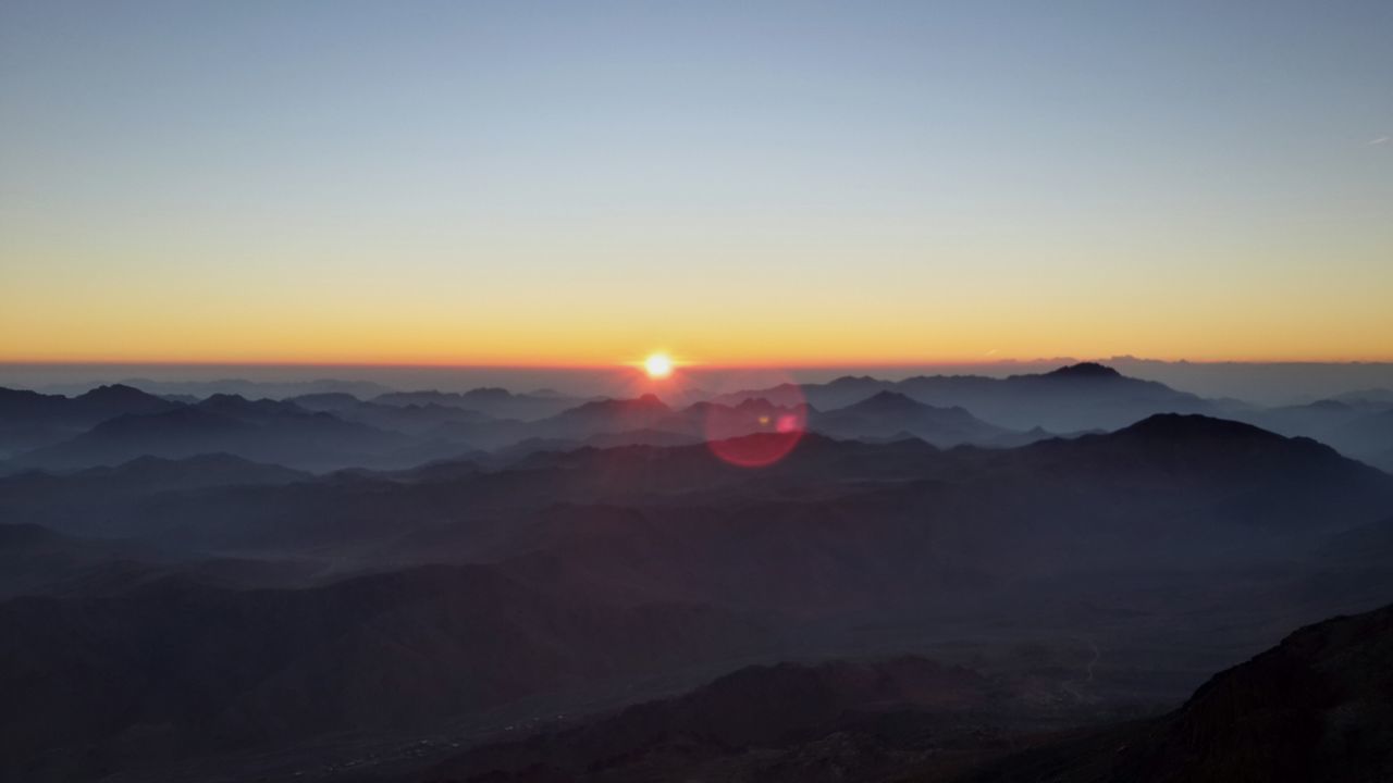 SCENIC VIEW OF MOUNTAINS AGAINST SKY AT SUNSET