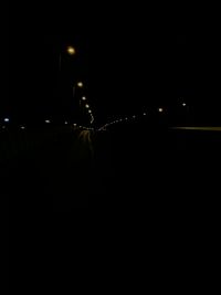 Illuminated street lights in city at night