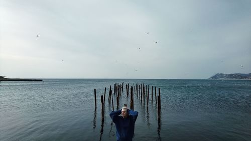 Man standing on beach against sky