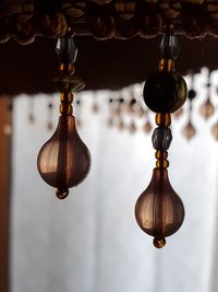 Low angle view of illuminated pendant lights hanging from ceiling