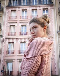 Young woman looking away in city