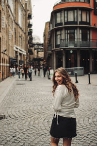 Portrait of smiling woman on street in city