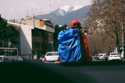 Rear view of person on road against sky