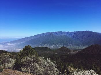 Scenic view of mountains against clear blue sky