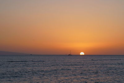 Scenic view of sea against orange sky