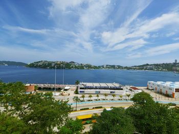 High angle view of buildings by sea against sky