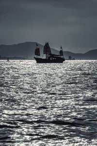 Ship sailing on sea against sky