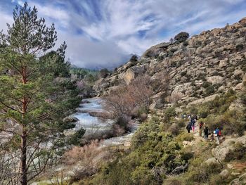 Flowing stream and hikers surrounded by beautiful mountainscape