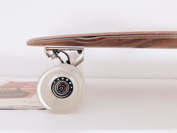 Close-up of camera on table against white background