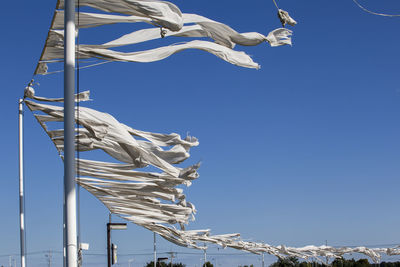 White fabrics waving against clear blue sky at imjingak