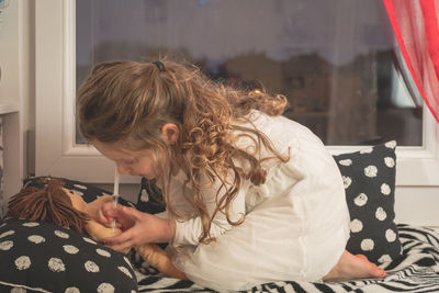 Midsection of woman sitting at home