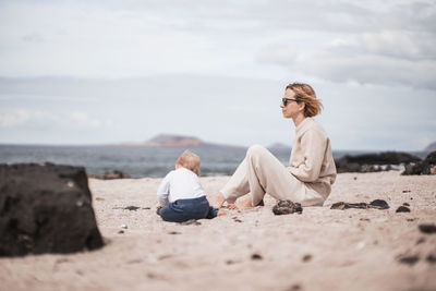 Young woman sitting on beach