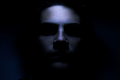 Close-up of man in darkroom