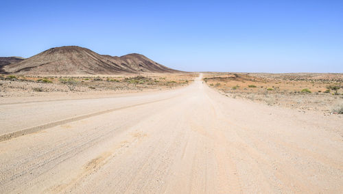 Scenic view of arid landscape against clear sky