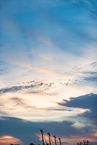 Low angle view of silhouette roof against sky during sunset