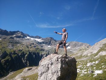 Man standing on rock against mountain