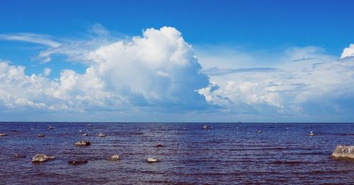 Scenic view of calm sea against cloudy sky