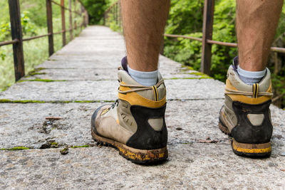 Low section of man standing on footpath