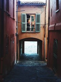 Narrow alley amidst buildings in city