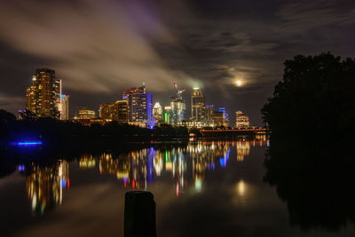 Illuminated buildings with waterfront at night