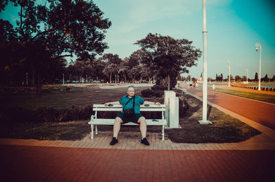 Man sitting on bench in park