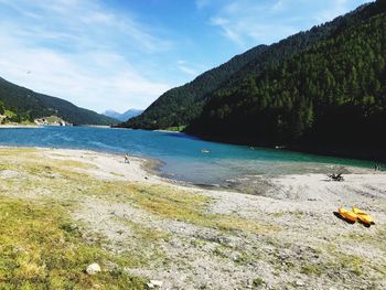 Scenic view of river amidst mountains against sky