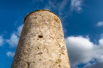 Low angle view of tower against cloudy sky