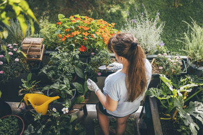 Woman holding trowel and doing gardening in balcony