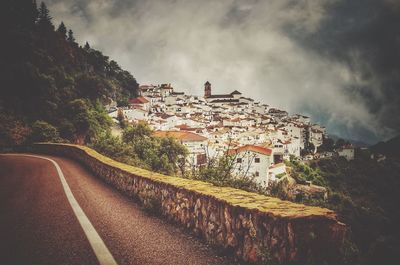 View of buildings against cloudy sky