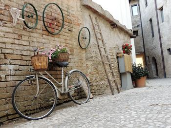 Bicycle parked against wall of building