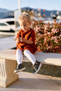 Full length of boy sitting on sunny day