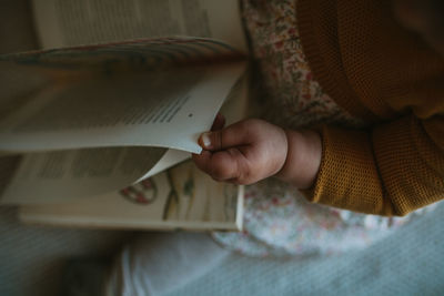 Close-up of hand holding book