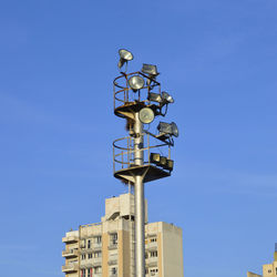 Low angle view of communications tower against blue sky