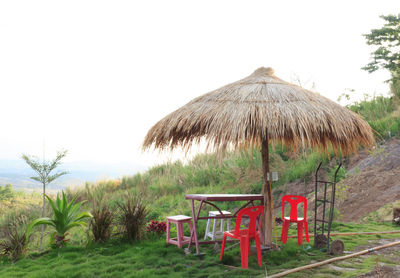 Hut on beach against clear sky