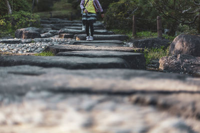 Low section of person standing on wood