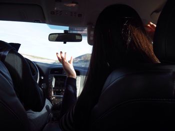 Rear view of people traveling in car