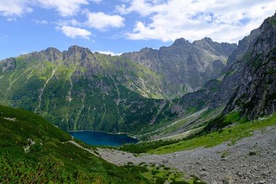 Scenic view of lake and mountains against sky