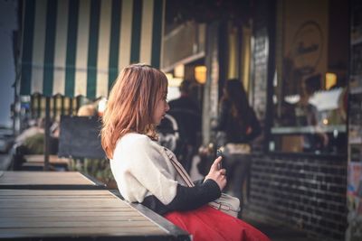 Close-up of woman standing on bench