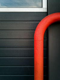 Close-up of red pipe on wall