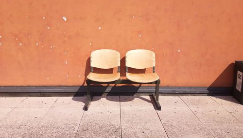 Empty chairs against tiled floor