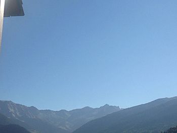 Scenic view of mountains against clear blue sky