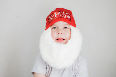 Portrait of woman wearing santa hat against white background