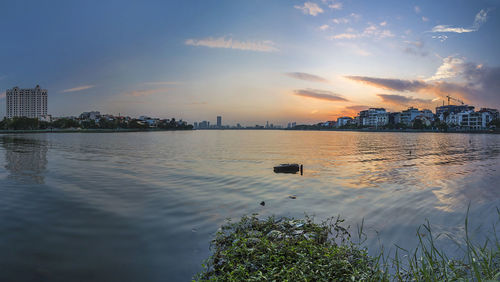 Scenic view of river against sky during sunset